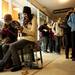 Ypsilanti residents Samantha Webster and Emma Smith use their phones and sit on a shopping cart while waiting in line at Target on Thursday. Daniel Brenner I AnnArbor.com